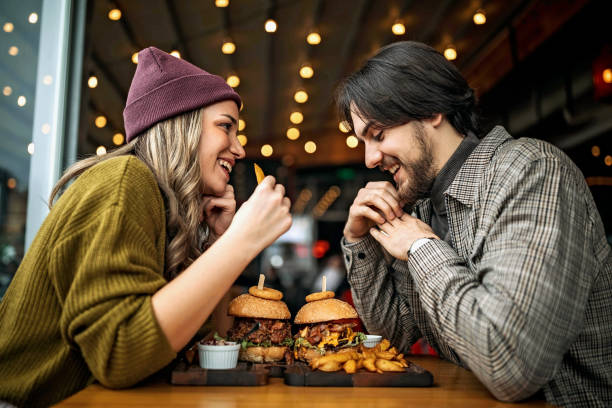 Young couple enjoying a delicious meal compliments of the Restaurant Network Rewards Program. 